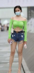 Green top with denim shorts