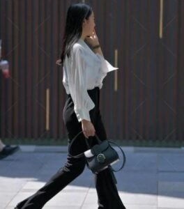 Read more about the article White long-sleeved shirt with black high-waisted trousers