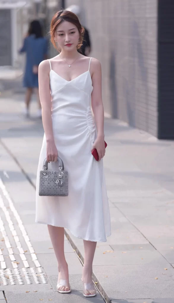 Knee-length white dress with transparent high heels